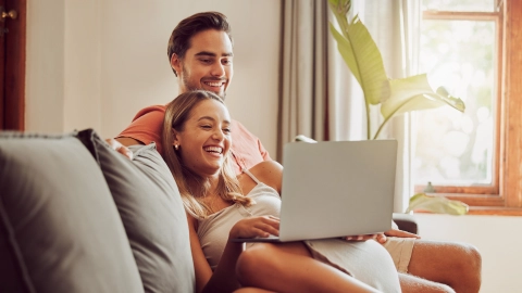 Jovens consultam informação sobre novas regras da habitação jovem num portátil